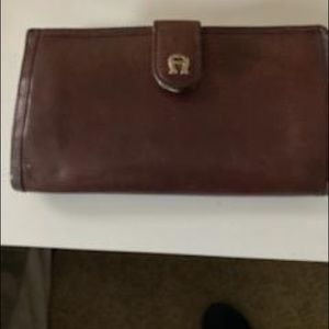 Etienne Aigner checkbook wallet wine colored.